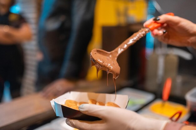 The process of making fresh delicious poffertjes Making fresh poffertjesTraditional Dutch batter treat Selective focus