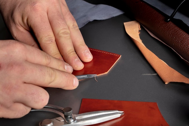 The process of making leather goods The hands of the master work with a leather product