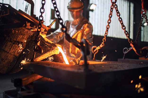 Process of pouring hot molten steel in foundry, metallurgy process and steel production.