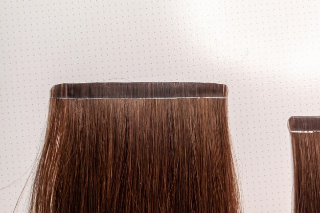 The process of preparing a hair ribbon for extension at home. Hair extensions to thicken your own