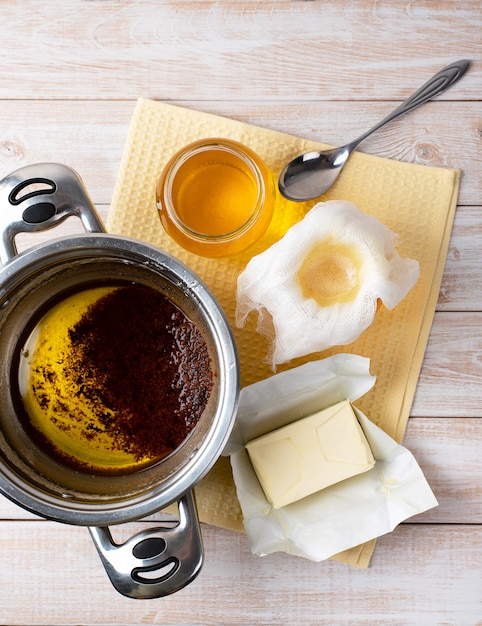 The process of preparing traditional Indian ghee butter: pouring and filtering through cheesecloth