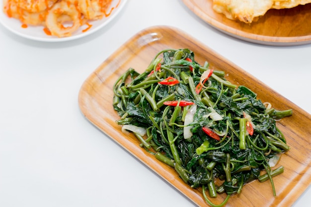 Processed kale Served on a wooden plate isolated on white background