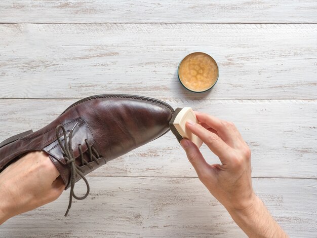 Processing shoes wax. man cleaning his shoes.