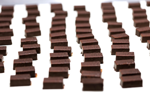 Production of chocolate candy Sweets on conveyor belt at factory