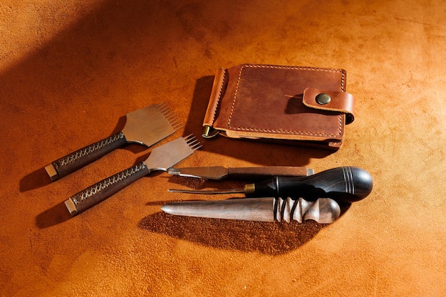 Production of handicrafts from genuine leather Tools for making leather goods and pieces of brown leather Production of leather products View from above