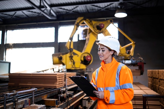 Production line worker checking quality of the products on conveyer belt machine