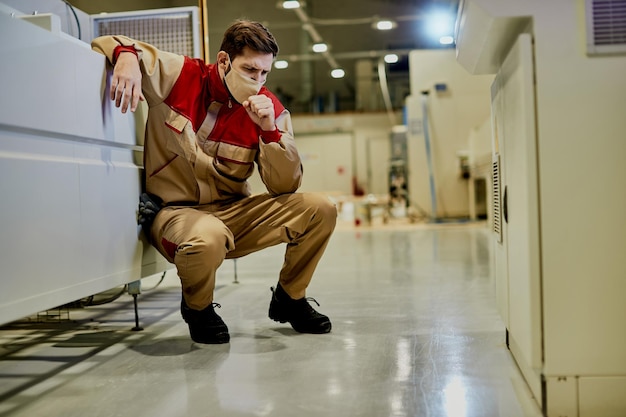 Production line worker feeling unwell and coughing at woodworking industrial facility