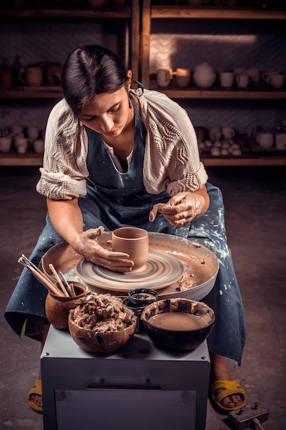 Production process of pottery Forming a clay teapot on a potters wheel