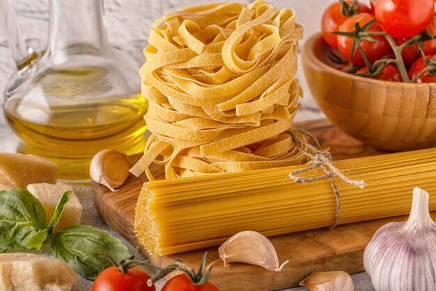 Products for cooking - pasta, tomatoes, garlic, olive oil, basil