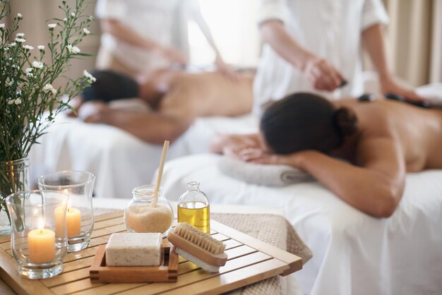 Photo products to please the senses shot of a mature couple enjoying a hot stone treatment