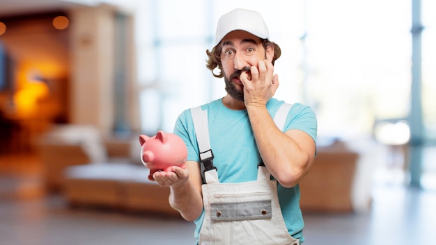 Profesional painter  with a piggy bank