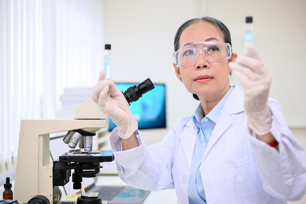 Professional aged Asian female scientist or chemist working in the lab