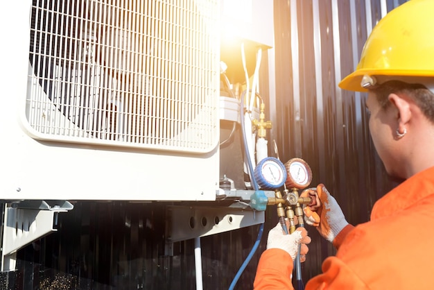 A professional air conditioner technician checking the refrigerant