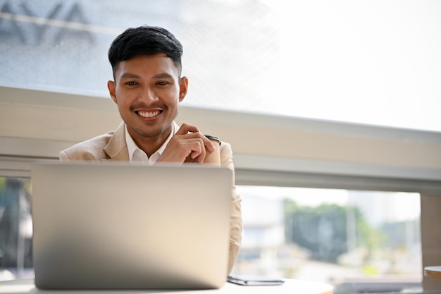 Professional Asian businessman working on his business project on laptop