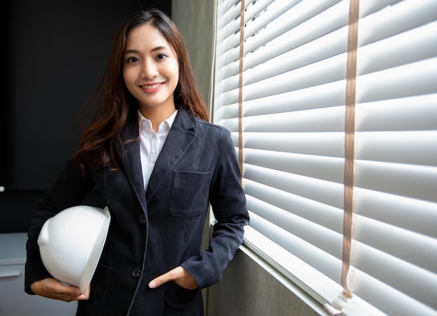 Professional Asian female engineer Standing confidently smiling in the office