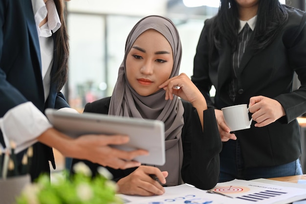 Professional Asian Muslim businesswoman pensive thinking a business plan with her coworker