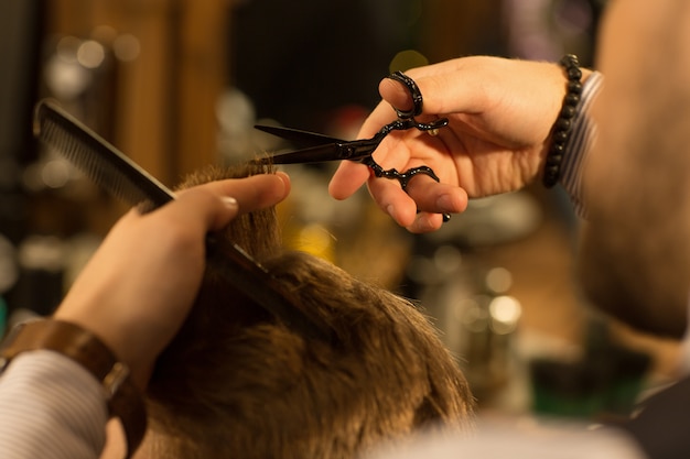 Professional barber working at his barbershop