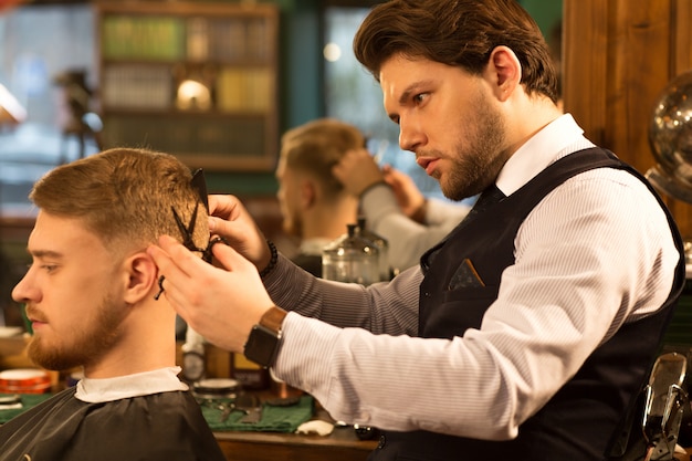 Professional barber working at his barbershop