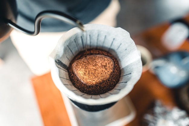 Professional barista preparing coffee pour over coffee maker and drip kettle