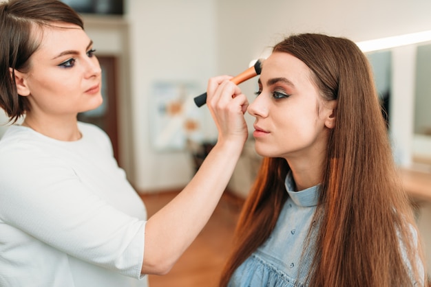 Professional beautician work with woman eyebrows