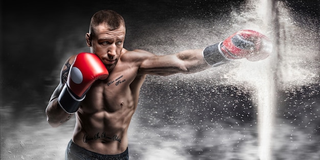 Professional boxer breaks the barrier with a glove. Dust and debris spilled over. 3d rendering. Sports concept. Mixed media