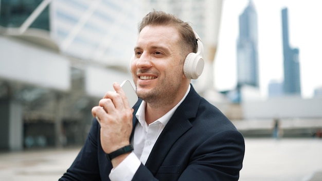 Professional business man listen headphone and using phone record voice Urbane