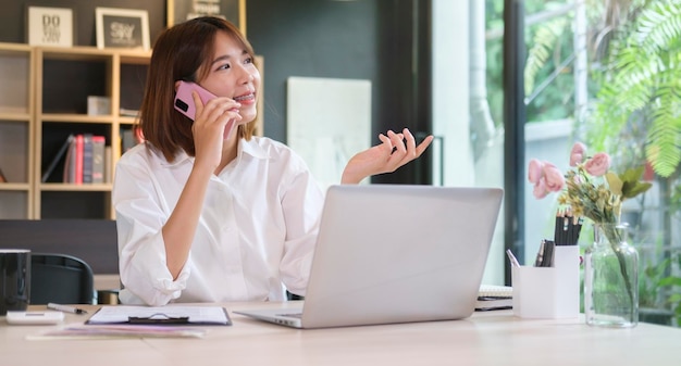 Professional businesswoman having phone conversation with her business partnerx9