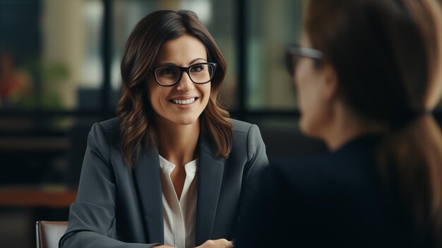 Professional businesswoman in a meeting with a colleague smiling and engaging in conversation