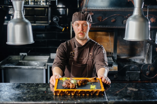 A professional chef beautifully serves a juicy grilled steak with butter and seasonings