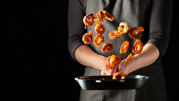 Professional chef prepares shrimps or langoustines