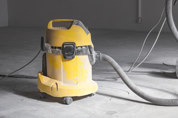 Professional construction vacuum cleaner at work warehouse repair