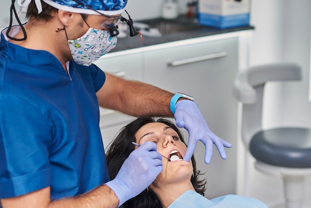 Professional dentist performs a scan on his patient.