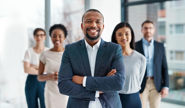 Professional diverse and successful business team smiling and standing together in an office Happy formal and multiracial corporate staff bank workers or businesspeople looking at camera