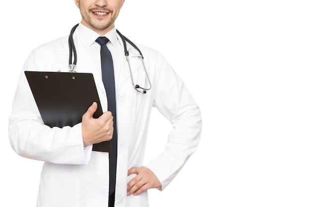 Professional doctor. Cropped shot of a handsome doctor checking medical results on his clipboard smiling happily copyspace on the side