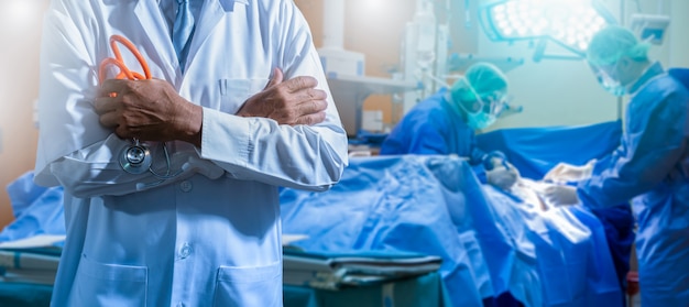 professional doctor and medical staff working at the hospital. Double exposure Several surgeons surrounding patient on operating table during their work.