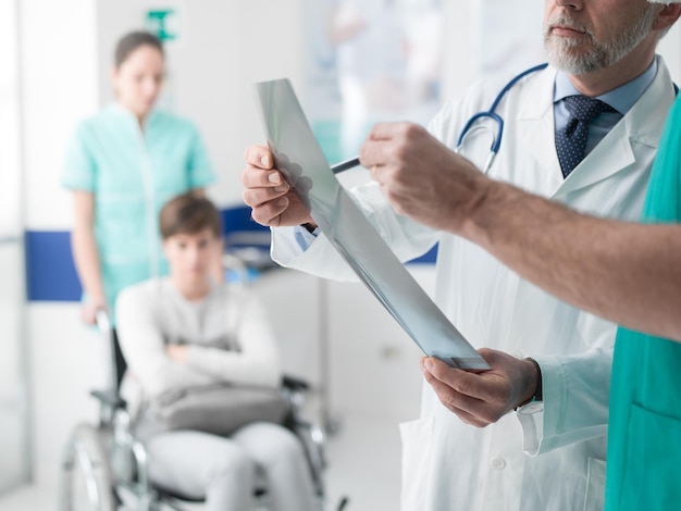 Professional doctors examining patient's xray