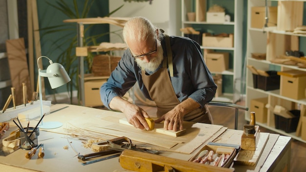 Professional Elderly Man Carpenter Working on Wood Using Carpentry Tools