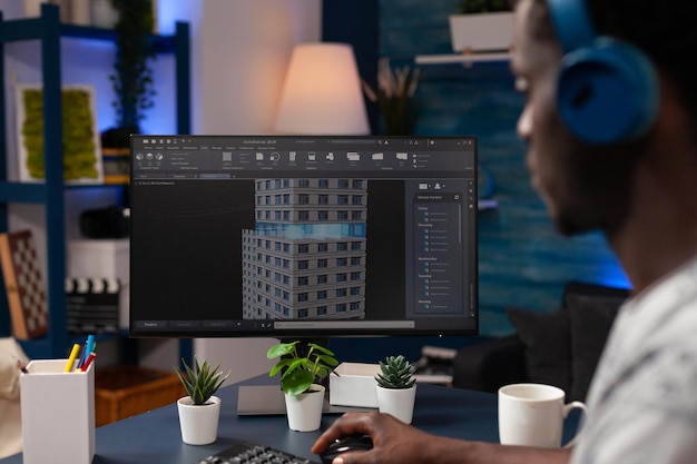 Professional engineer developer working remote from home at building prototype on computer analyzing architectural construction. Real estate architect designing construction layout creating sketch