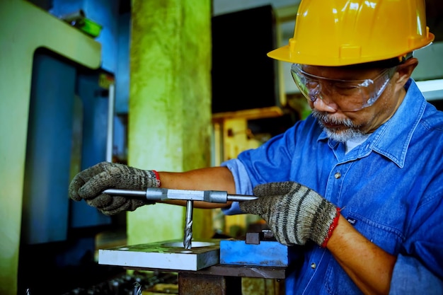 Professional engineer man technician operator Inspecting factory working machines machine maintenance concept