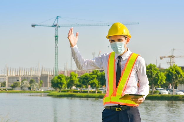 Professional engineer standing outdoors on construction site  working.