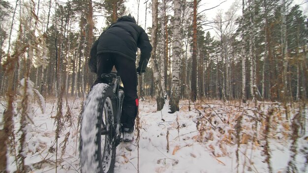 Professional extreme sportsman biker riding fat bike in outdoor