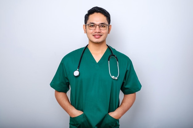 Professional goodlooking asian doctor medical worker in glasses and scrubs cross arms and smiling