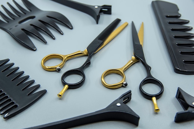 Professional hairdressers tools isolated on gray background hairdressers scissor comb and hairpins