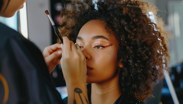 Photo a professional makeup artist is seen applying eye makeup to a model inside a studio aig62