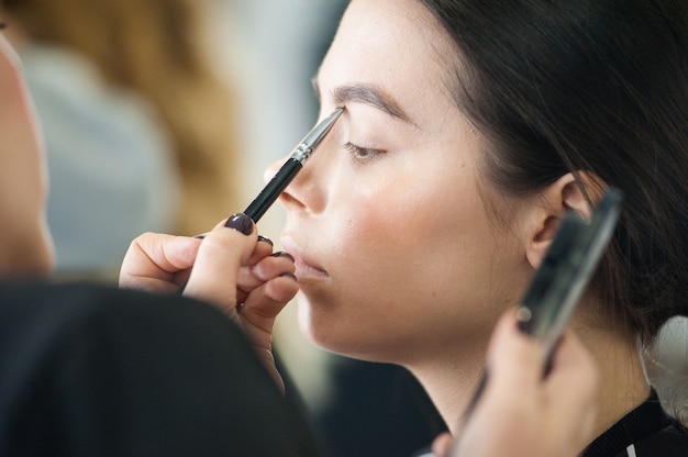 Professional makeup for a woman in a beauty studio