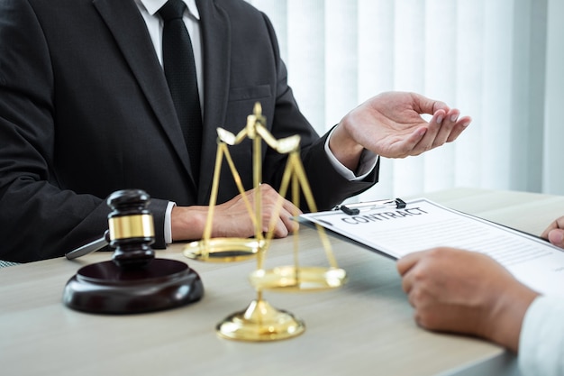 Professional Male lawyer or counselor discussing negotiation legal case with client meeting with document contract in office, law and justice, attorney, lawsuit concept.