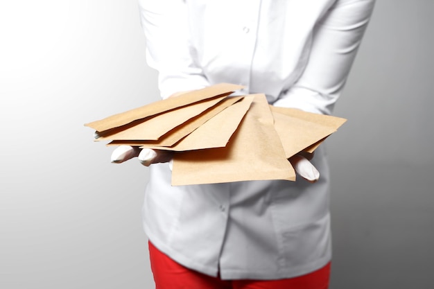 Professional manicurist doctor holding paper bags with with sterile tools