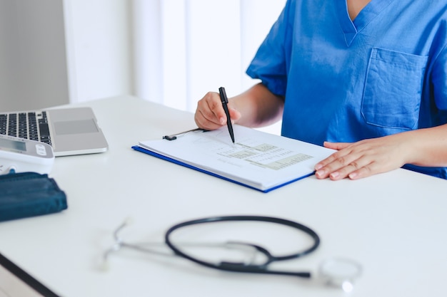 Professional medical doctor in white uniform gown coat interview consulting patient.