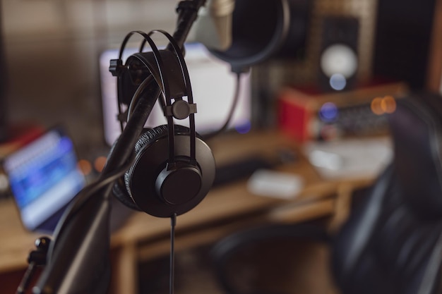 Professional microphone and headphones in the workplace for broadcasting and music rehearsal space