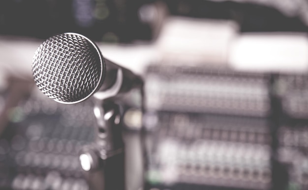 A professional microphone on recording studio background